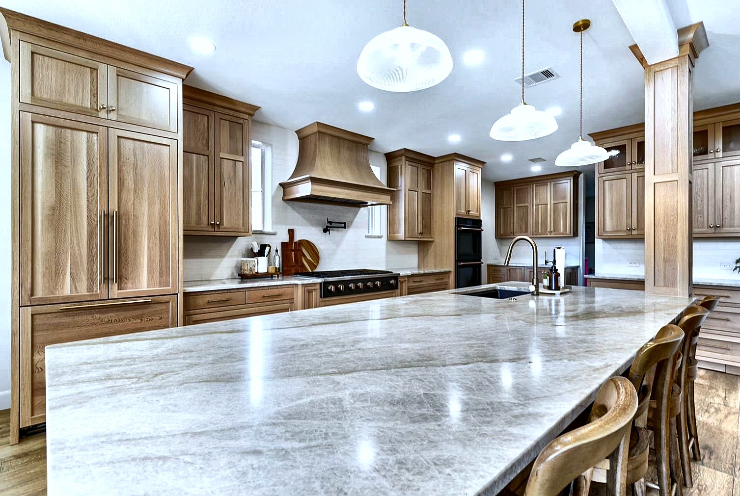 Custom light wood kitchen extra-large stone island