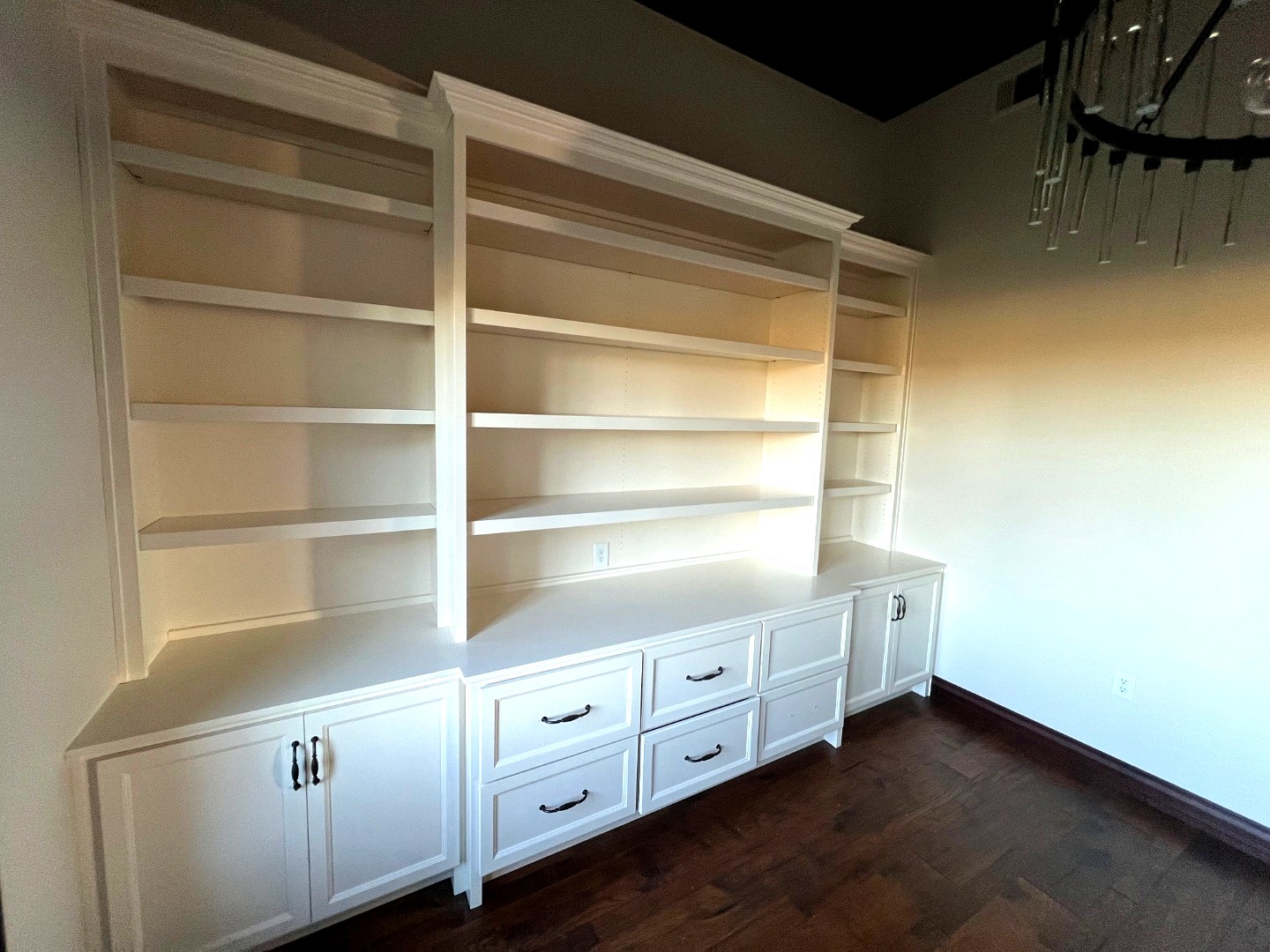 White built-in shelving wall unit with drawers