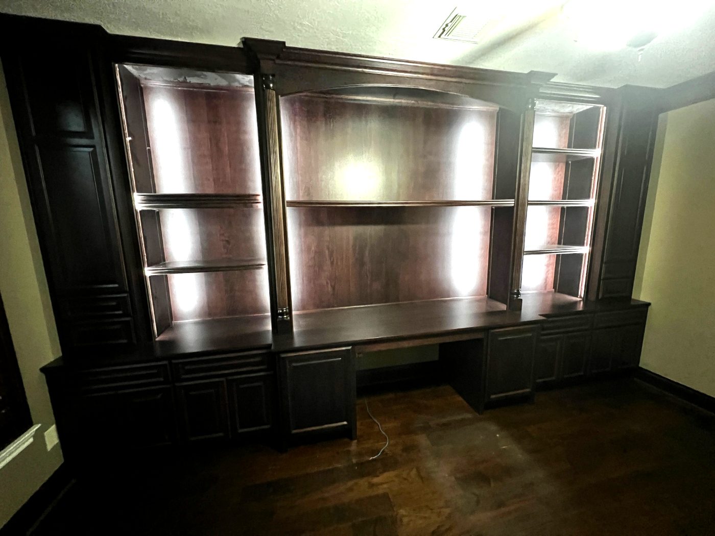 Espresso built-in home office desk wall with lighted bookshelves