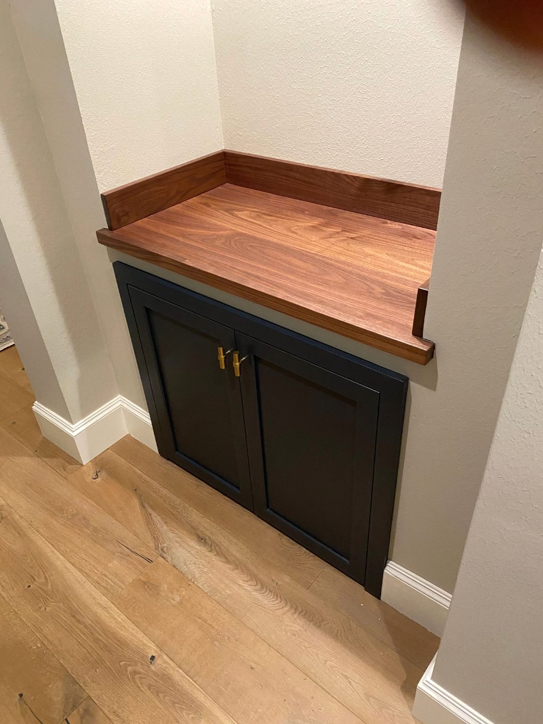 Navy painted nook cabinet with solid walnut countertop and brass hardware