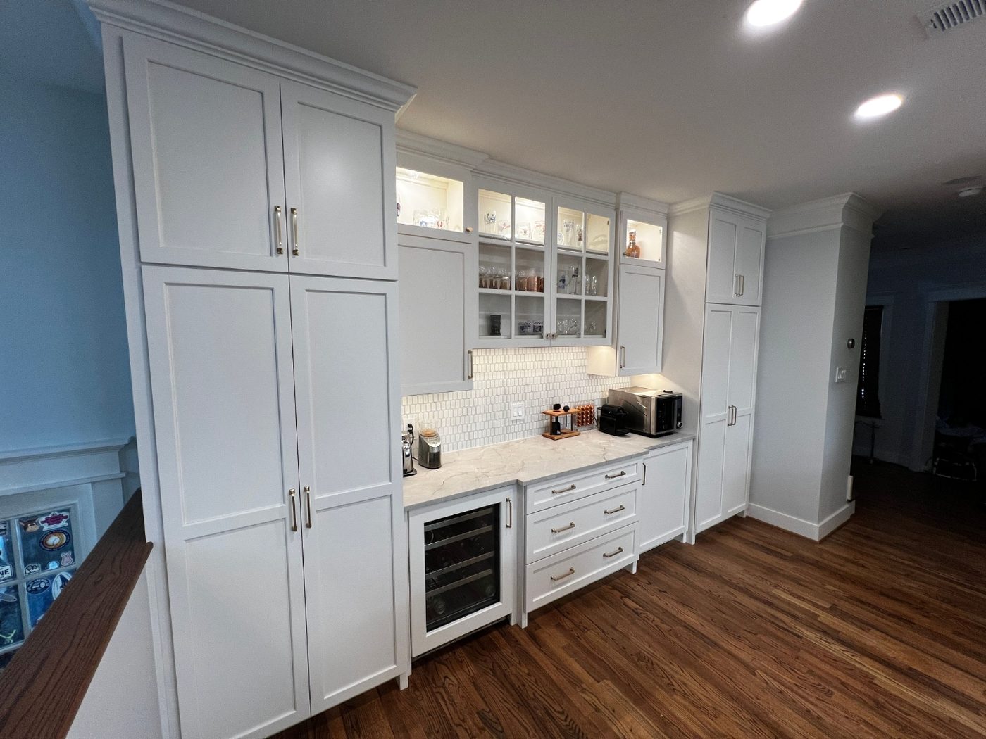 Custom pantry and butler pantry cabinetry with wine fridge and glass-front uppers