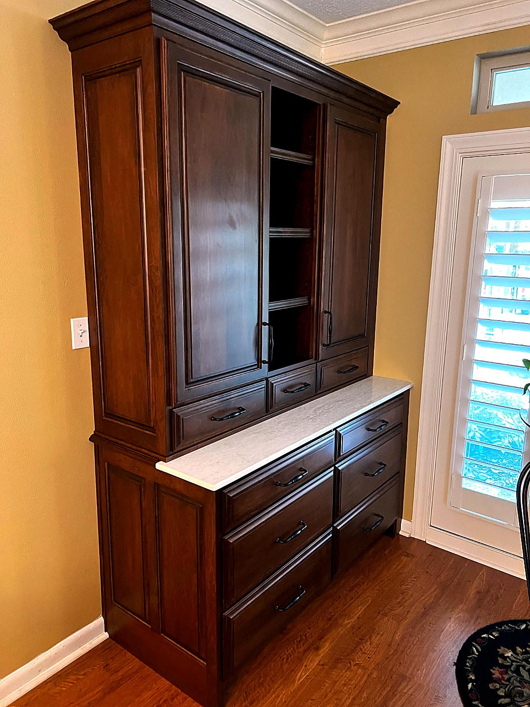 Custom cherry bedroom built-in with dresser and upper cabinets