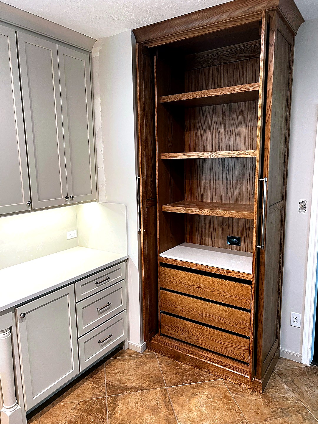 Custom pantry armoire with grey base cabinets