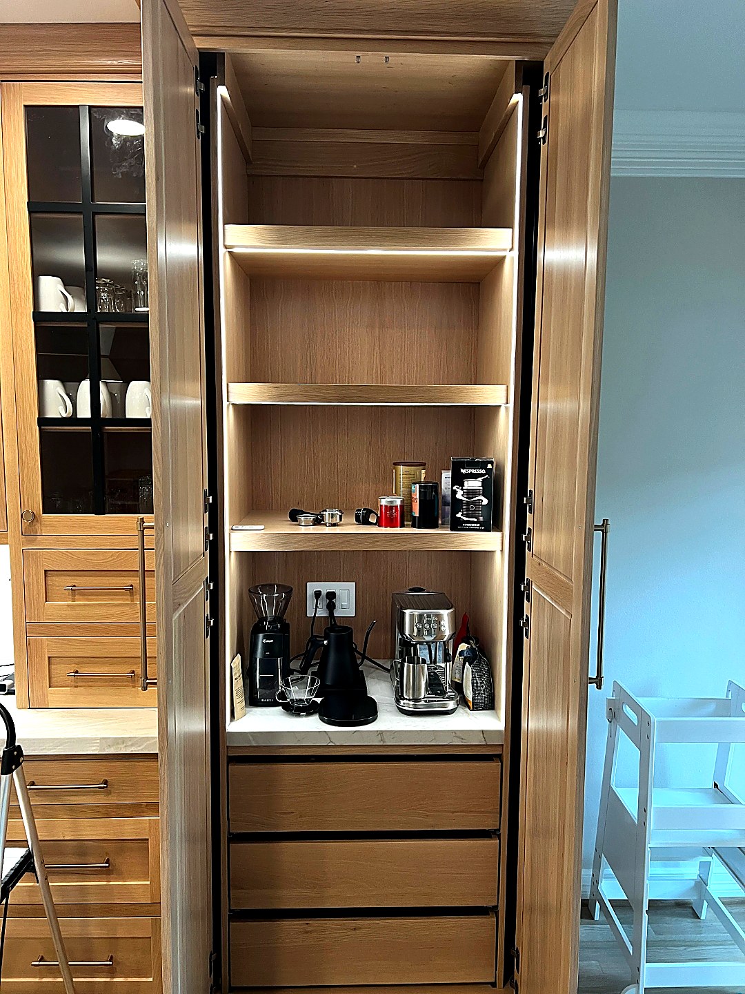 Custom appliance and coffee bar cabinet with lighted shelves