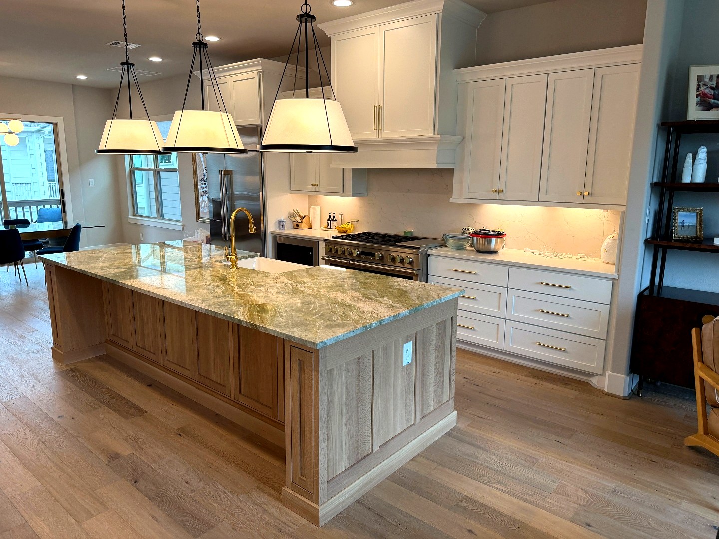 White shaker cabinets with green quartzite island