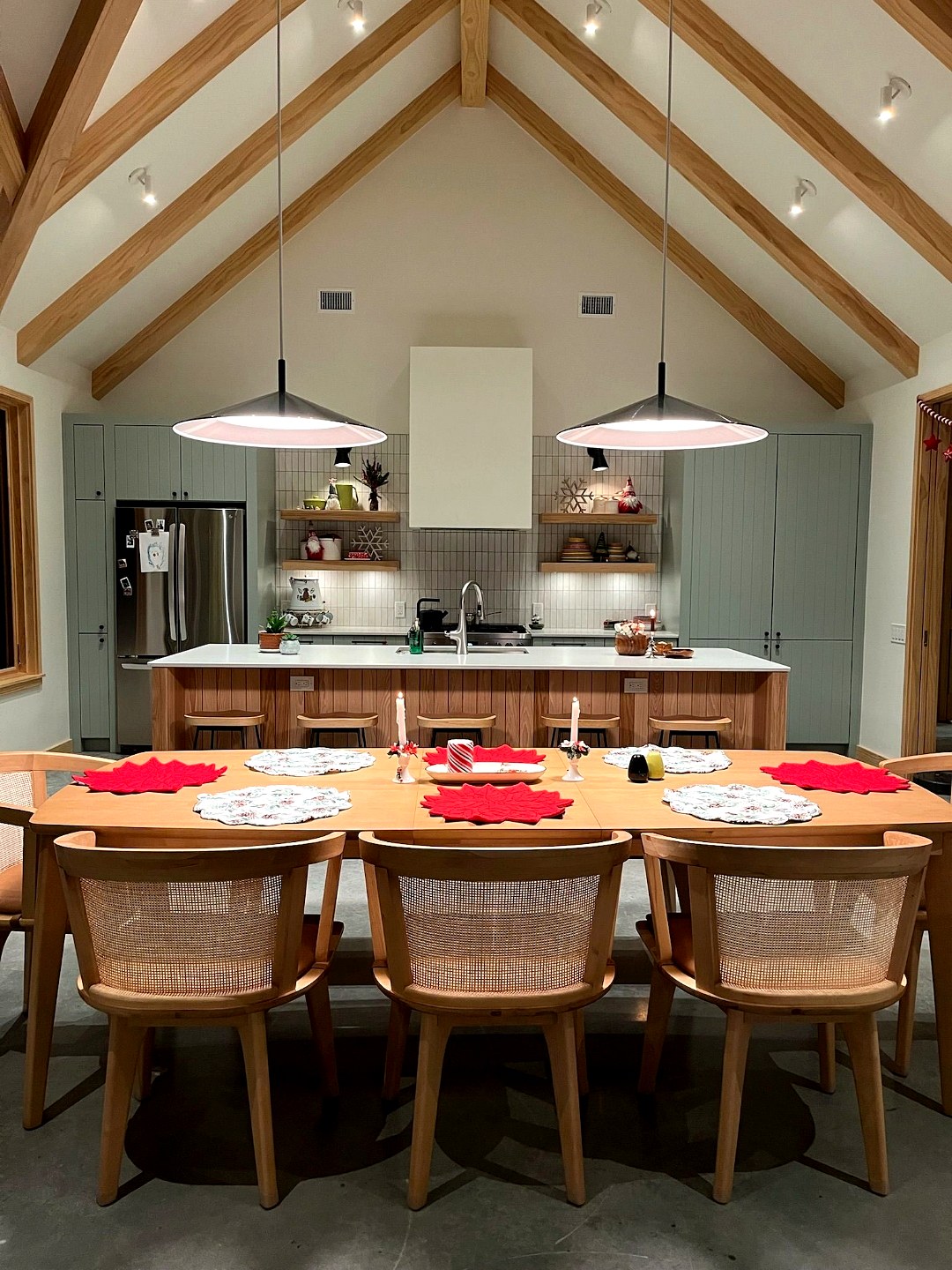 Open dining area with custom sage cabinetry