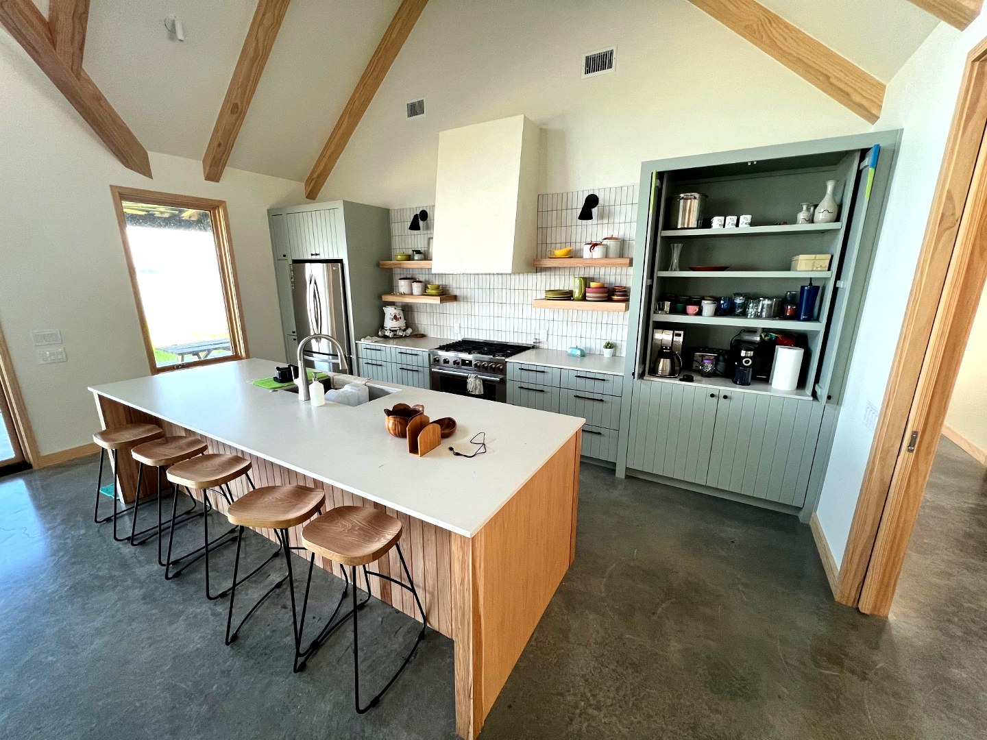 Sage green barnhouse kitchen with open shelving