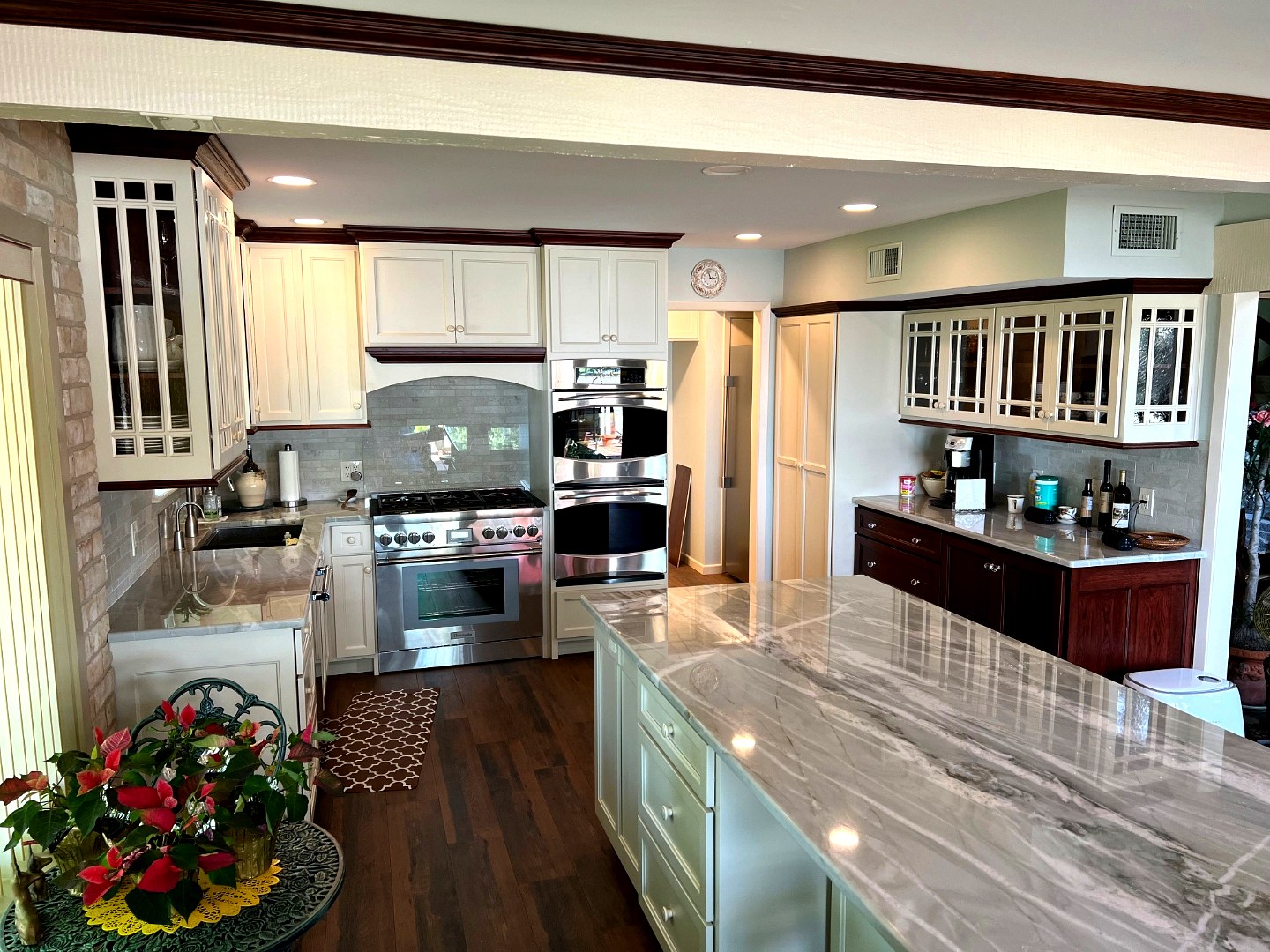White and cherry kitchen with marble waterfall island